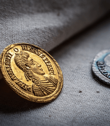 The Patching Hoard was discovered by two metal detectorists, Terry Bromley & Terry Silver, in a field near Patching village in 1997. A total of 23 gold solidi, 27 silver siliquae, 2 gold rings of exceptional purity and a Roman-pound weight of hack silver were recovered from the site. The hoard is one of the last ‘Roman’ coin hoards to be found in Britain, much of it being acquired on the Continent and brought into Sussex at a time when the Western Roman Empire was crumbling and new polities were emerging on either side of the Channel.